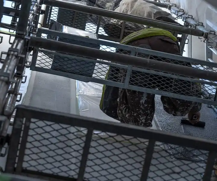 足場で塗装している画像